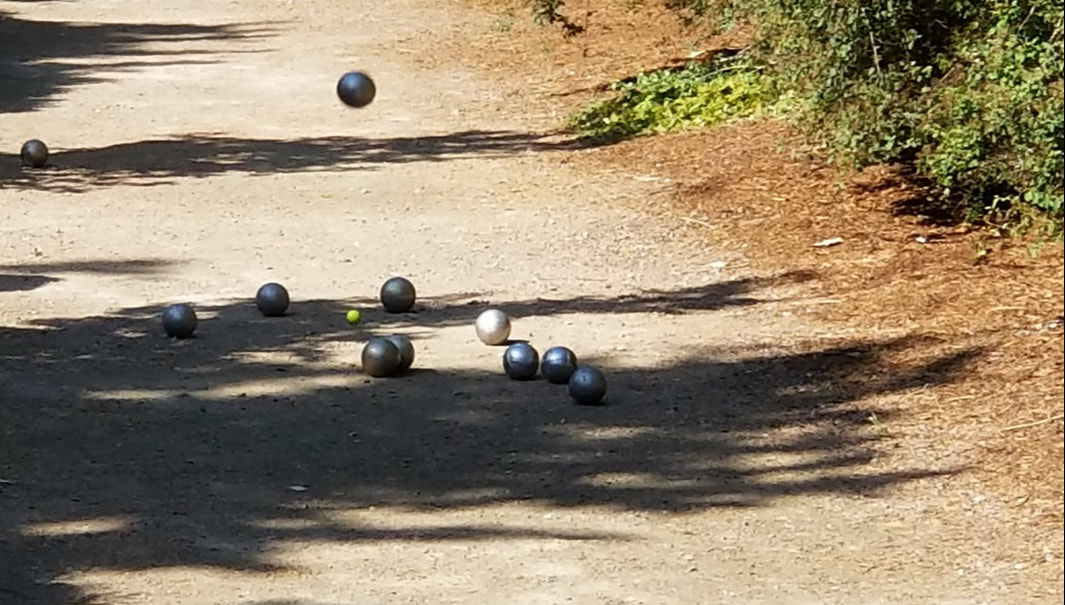 Pétanque players on a gravel court